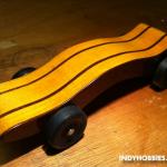 This car was created by carefully slicing the original block of pine and then laminating some mahogany along with the pine.  Then, the shape was cut out.  This was created for the Brownsburg Motorsports Celebration Pinewood Derby.  You can find more information on this great eve