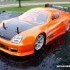 This is an HPI Honda Prelude.  Paint is Faskolor metallic orange, trimmed with neon orange and white.  Faux carbon fiber hood.  Minimum decals.  Great looking body on the track!
