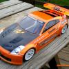 This is an HPI Nissan 350Z "Nismo" edition body.  190mm for touring cars.  Its sitting on an Associated TC6 chassis.  Neons don't show up all that well in photos.  But, its metallic orange and neon orange.  Faux carbon fiber on the hood.  You can see it on the track!