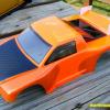 This is a 1/18 scale short couse body.  Neon orange and metallic orange.  Small, but very visable!