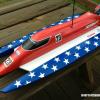 This is a Dumas HotShot Sprint converted to electric power (1500KV motor x 4S lipo!).  I though a good patriotic scheme looked awesome on this tunnel hull!