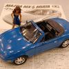 This is a Tamiya Miata model that I built.  1/25 scale.  I don't know where she came from...  I put the model on the table and apparently she walked over to see it.