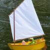 This is a Pram Dinghy day sailer that I built from scratch using RC Modeler 1991 plans.  It is constructed of Sintra PVC, mahogany and cherry wood and lots of hours.  Kermit is connected to the tiller arm and looks alive when steering the boat!  